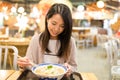 Woman enjoy her japanese ramen in restaurant Royalty Free Stock Photo