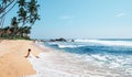 Woman enjoy with ocean surf sitting on the lonely tropical beach Royalty Free Stock Photo