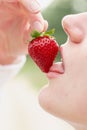 Woman enjoy strawberry close-up. Kisses and tastes strawberry. Seasonal berry Royalty Free Stock Photo