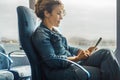 Woman enjoy travel leisure using mobile phone on board seats and having relax. Cruise ship boat seats and people traveling. Royalty Free Stock Photo