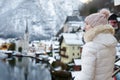 Woman enjoy winter scenic view of village of Hallstatt in the Austrian Alps