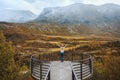 Woman enjoying autumn landscape on Vegaskjelet viewpoint travel outdoor aerial view forest and mountains Royalty Free Stock Photo