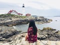 Woman enjoying beautiful view of Portland lighthouse in Portland Maine USA Royalty Free Stock Photo