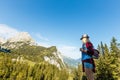 woman enjoying beauty of nature looking at mountain. Adventure travel, Europe. Woman stands on background with Alps. Royalty Free Stock Photo