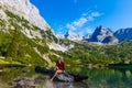 woman enjoying beauty of nature looking at mountain. Adventure travel, Europe. Woman stands on background with Alps. Royalty Free Stock Photo