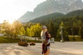 woman enjoying beauty of nature looking at mountain. Adventure travel, Europe. Woman stands on background with Alps. Royalty Free Stock Photo