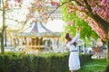 Woman enjoying cherry blossom season in Paris, France