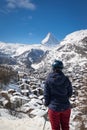 Woman enjoying cityscape of Zermatt, Switzerland with Matterhorn
