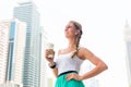 Woman enjoying coffee to go in metropolitan city
