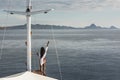 Woman enjoying cruise on luxury white yacht. Wealth and freedom travel concept