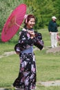 Asian Woman Enjoying Cultural Event in Park