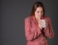 Woman enjoying a cup of coffee in a tacky business suit