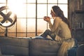 Woman enjoying cup of hot beverage in apartment Royalty Free Stock Photo