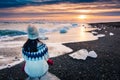 Woman enjoying Diamond beach sunset in Iceland