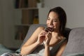 Woman enjoying eating chocolate in the night