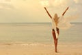 Woman enjoying freedom on a beach at sunset Royalty Free Stock Photo