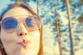 Woman tourist enjoying fresh air in the woods and sending air kiss Royalty Free Stock Photo