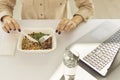 Woman enjoying healthy takeaway lunch and drinking fresh water during working day in office Royalty Free Stock Photo