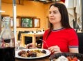 Woman enjoying her meal, eating parillada de carne