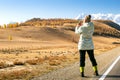 Woman Enjoying Landscape Of Autumn Mountains. Woman Hiker Taking Photo Royalty Free Stock Photo