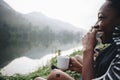 Woman enjoying morning coffee by a river Royalty Free Stock Photo