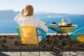 Woman enjoying morning in luxury hotel in Santorini