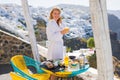 Woman enjoying morning in luxury hotel in Santorini