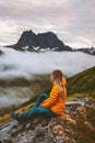 Woman enjoying mountains view traveling alone