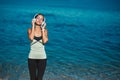 Woman enjoying music in headset. Calm sea and fresh air. Meditation time and contemplation nature concept, copy space Royalty Free Stock Photo