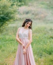 woman enjoying nature in delicate elegant pink silk dress with white lace top Royalty Free Stock Photo