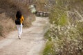 A young traveler girl sit on the top of valley. Young girl love wild life, travel, freedom.