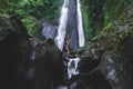 Woman enjoying near hidden in jungle cascade waterfall Dusun Kuning in Bali Royalty Free Stock Photo