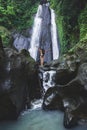 Woman enjoying near hidden in jungle cascade waterfall Dusun Kuning in Bali Royalty Free Stock Photo