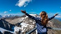 Woman enjoying the panoramic view from Hoher Sonnblick on mountain ranges of High Tauern Alps in Carinthia, Salzburg, Austria,