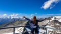 Woman enjoying the panoramic view from Hoher Sonnblick on mountain ranges of High Tauern Alps in Carinthia, Salzburg, Austria,
