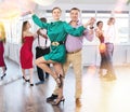 Woman enjoying passionate Latin American dancing with male partner in dance hall Royalty Free Stock Photo