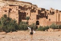 Woman enjoying popular landmark ksar Ait-Ben-Haddou. View from behind Royalty Free Stock Photo