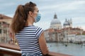 Woman enjoying promenade on Accademia bridge in Venice, Italy