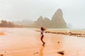 Woman enjoying rainy fall tropical beach Thailand Royalty Free Stock Photo