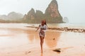 Woman enjoying rainy fall tropical beach Thailand Royalty Free Stock Photo