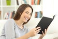 Woman enjoying reading a book at home