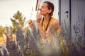 Woman enjoying the scent of Lavender on a farm