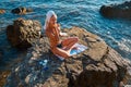 Woman enjoying sea view. Lady using beauty products outdoors. Health, spa day and rest on fresh air concept. Copy space