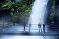 Woman enjoying Situ Gunung waterfall view Royalty Free Stock Photo
