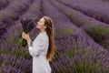 Woman Enjoying Smell of Lavender Flowers in Field Royalty Free Stock Photo