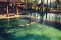 woman enjoying the sun at infinity summer swimming pool at luxurious resort and spa hotel Royalty Free Stock Photo