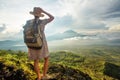 Woman enjoying sunrise from a top of mountain Batur, Bali, Indonesia