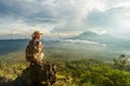 Woman enjoying sunrise from a top of mountain Batur, Bali, Indonesia