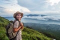 Woman enjoying sunrise from a top of mountain Batur, Bali, Indonesia