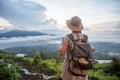 Woman enjoying sunrise from a top of mountain Batur, Bali, Indonesia